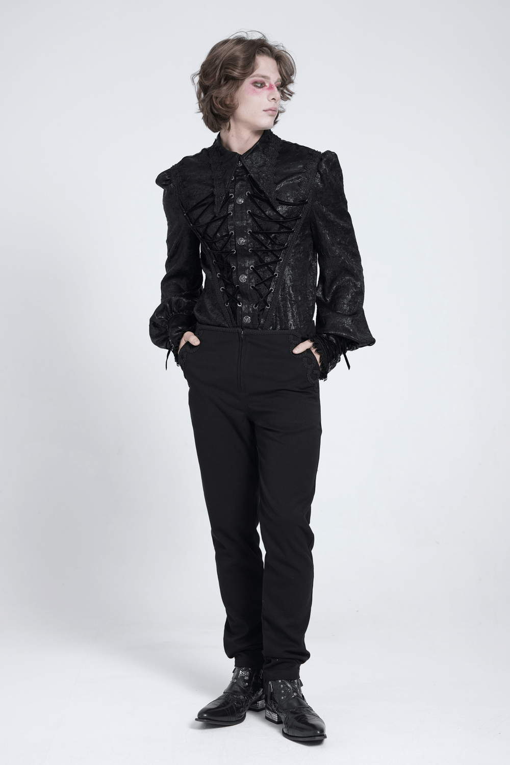 Stylish model in a black Gothic Victorian lace-up shirt with puff sleeves, showcasing dramatic elegance.