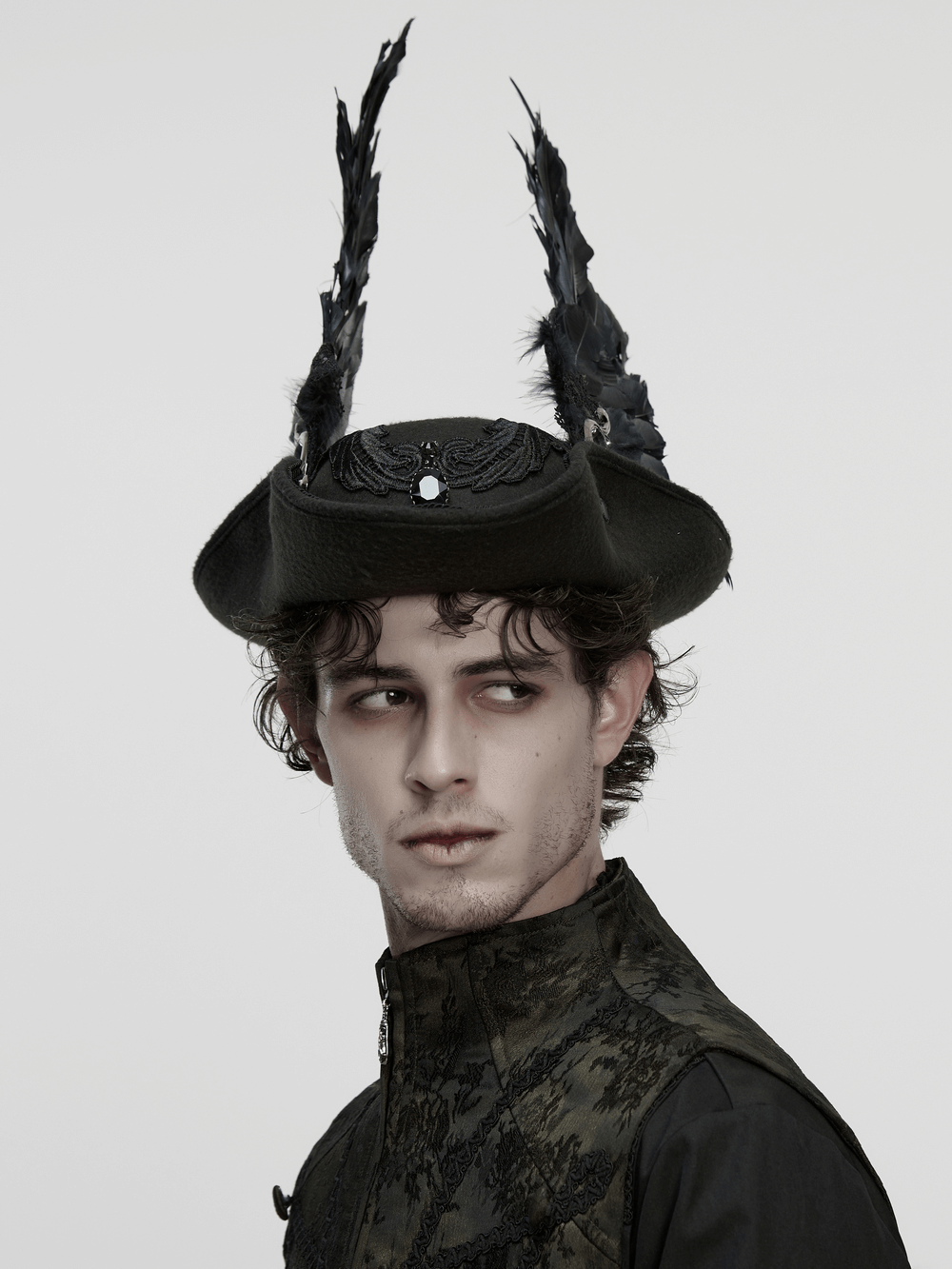 Black Gothic Wool Hat with Feathered Demon Wings worn by a model with dramatic expression and dark attire.