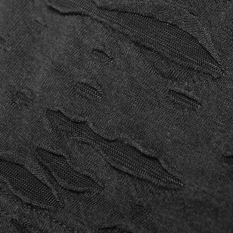Close-up of black broken-hole knit fabric showcasing edgy distressed details for a punk-inspired look.