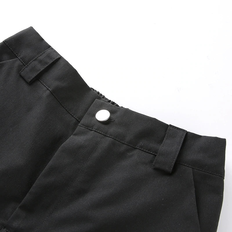 Close-up of black high waist cargo pants with stylish buckle and button details, perfect for women’s street style.