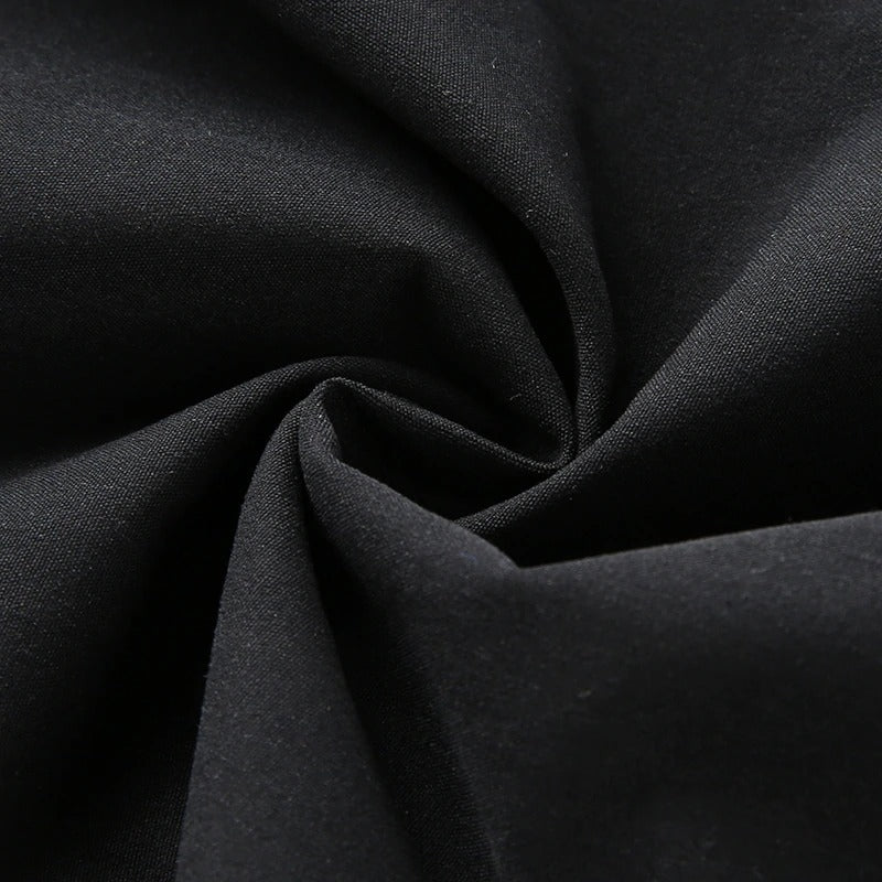 Close-up of soft black fabric, showcasing the texture of high waist cargo pants for stylish women's street fashion.