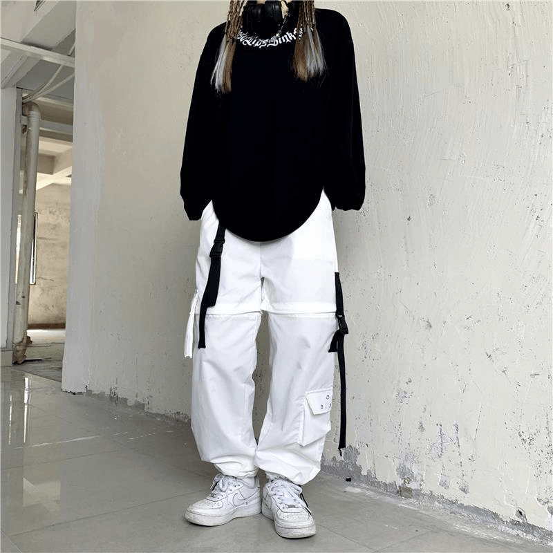 Chic black oversized top paired with trendy white high waist cargo pants for a stylish streetwear look.