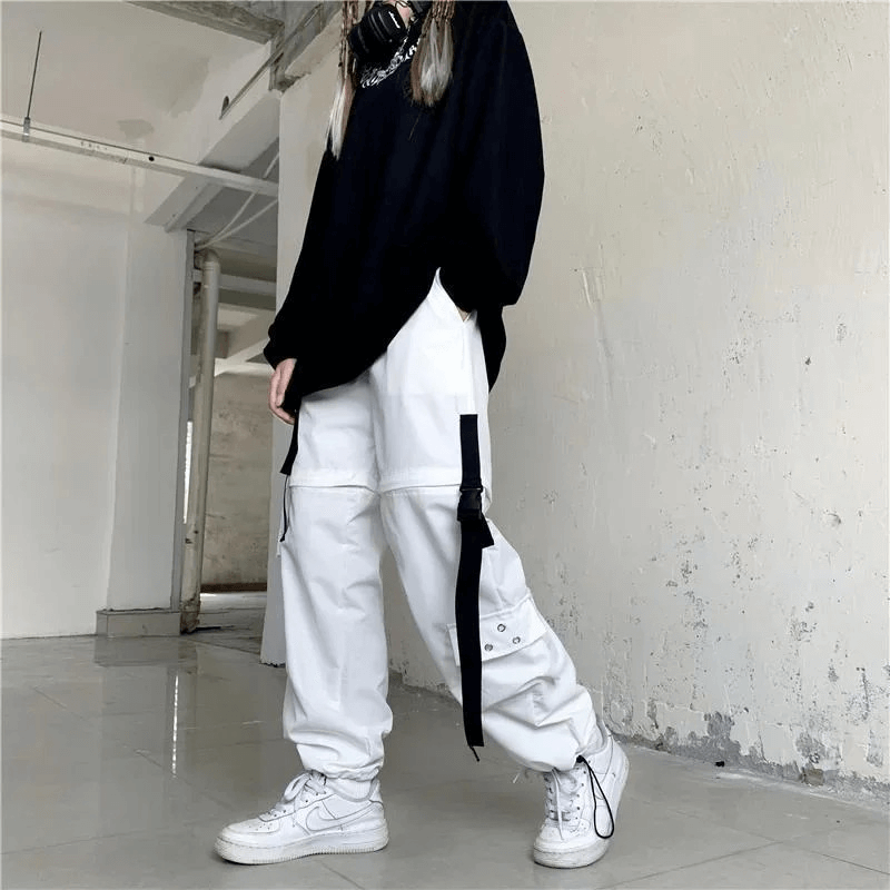 Stylish white cargo pants paired with a black oversized sweater and sneakers, ideal for a trendy street style look.