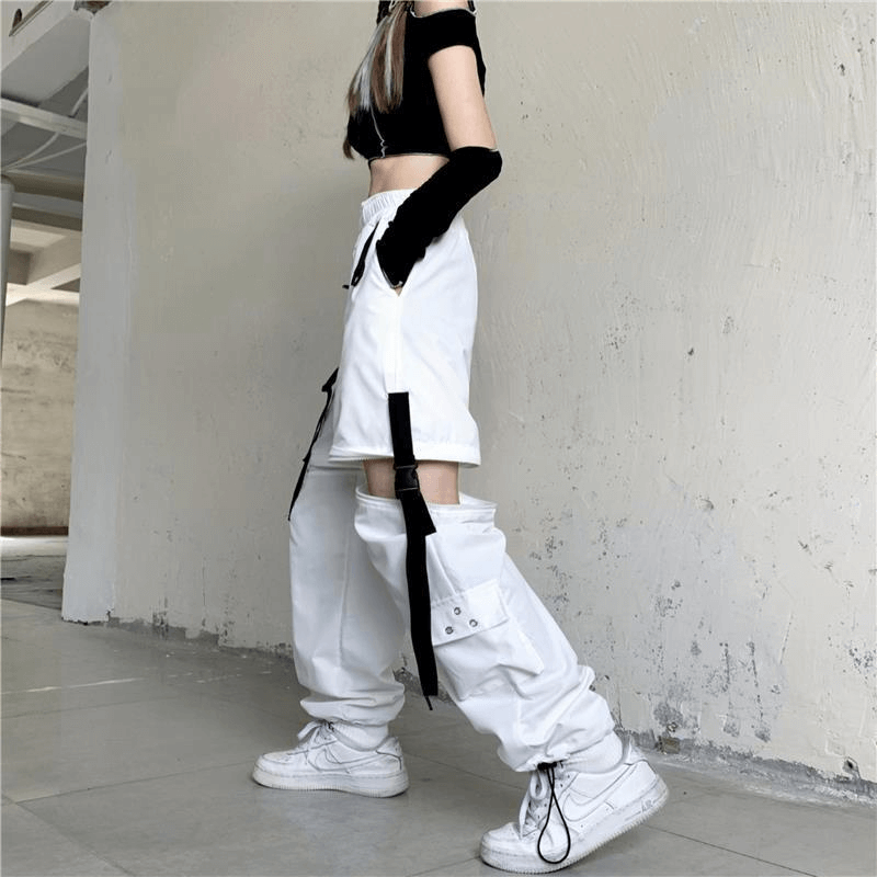 Stylish white cargo pants with buckle details, perfect for street style outfits and dance performances.