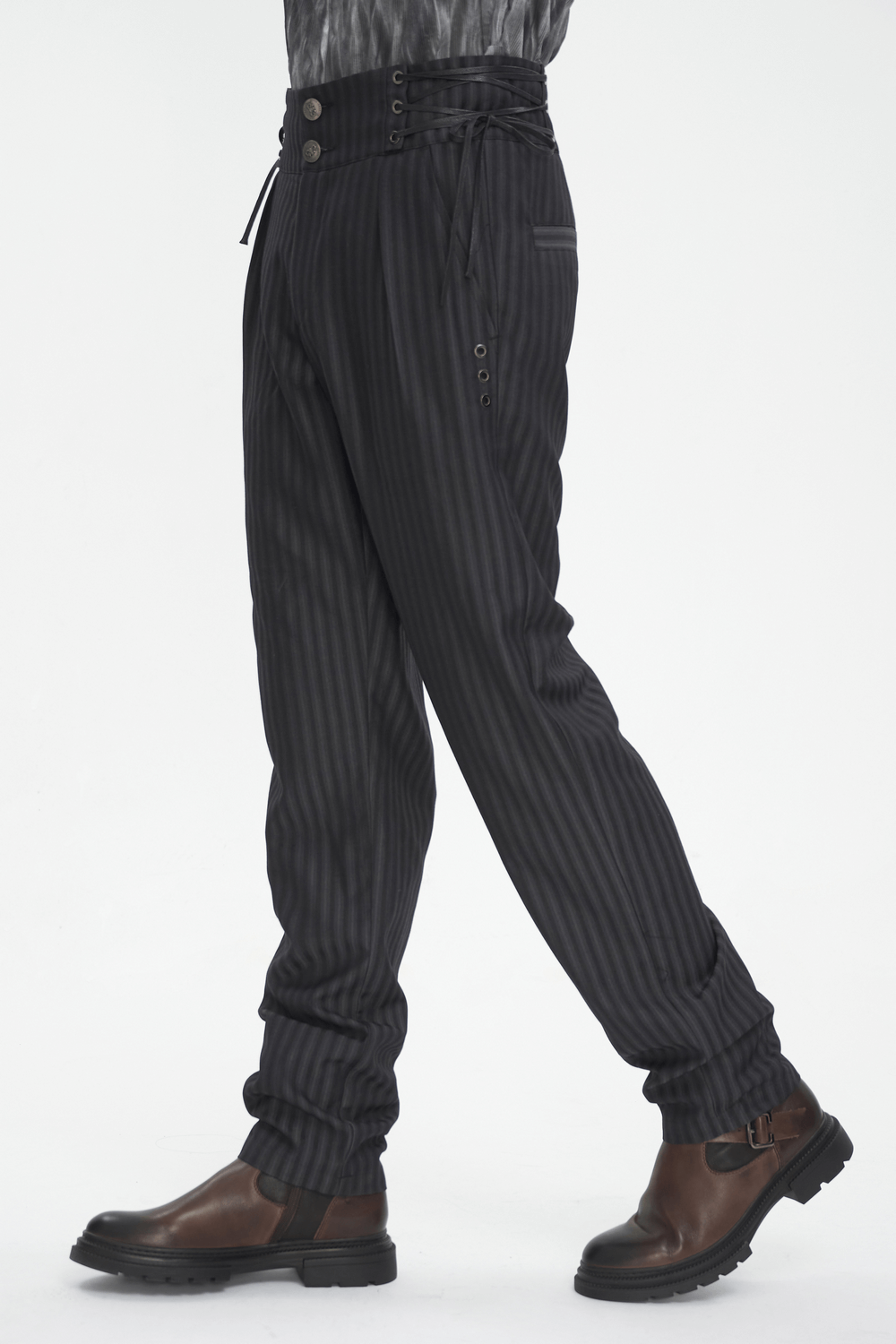 Black high-waisted striped trousers with lace-up sides, stylishly paired with rugged boots.