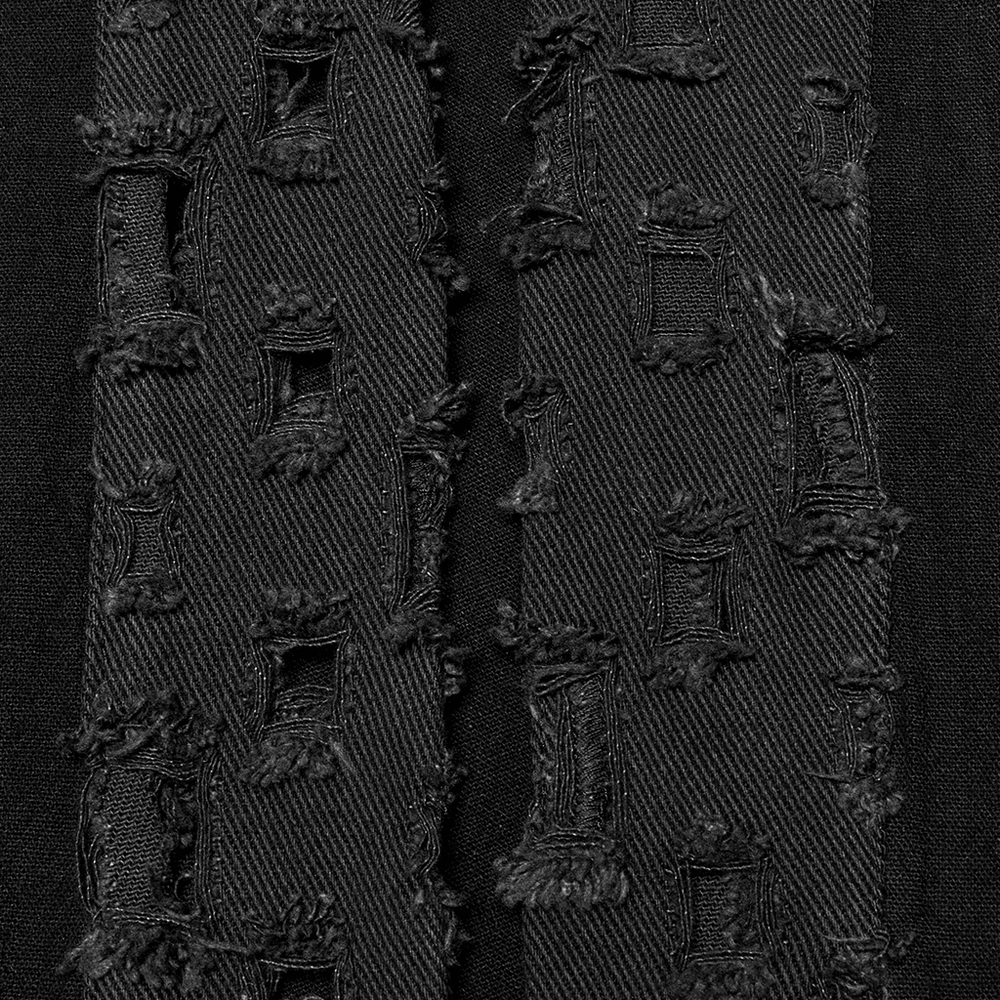 Close-up of textured black fabric featuring intricate lace patterns and distressed details for a gothic aesthetic.