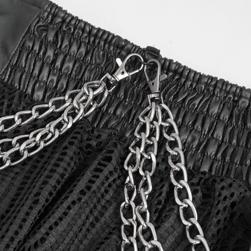 Close-up of black skirt featuring edgy metal chain details and flexible smocked waistband.