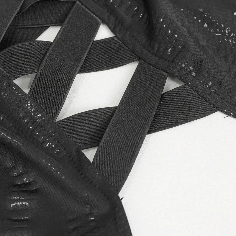Close-up of black dress detailing with mesh and strap design, showcasing a chic and modern aesthetic.