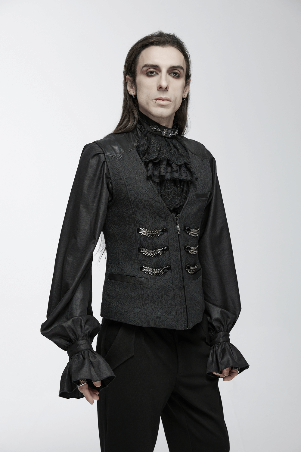 Stylish man in a black jacquard dragon scale gothic waistcoat with ruffled shirt, showcasing a dark, elegant aesthetic.