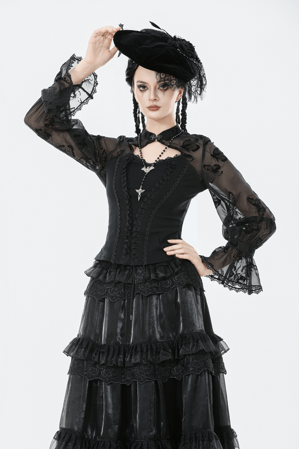 Black Lace and Velvet Butterfly-Detail Victorian Top showcased with an elegant hat and layered lace skirt.