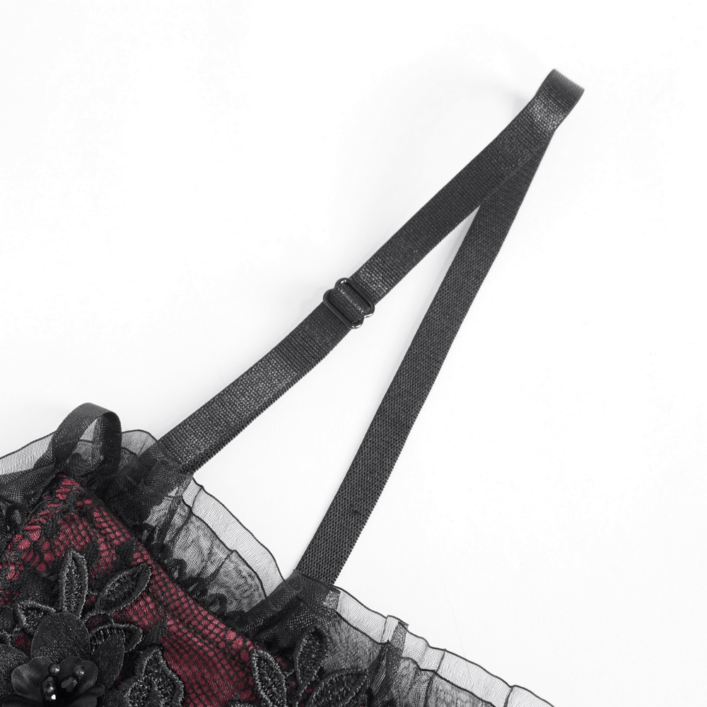 Close-up of delicate black lace top strap showcasing intricate floral embroidery and sheer texture.