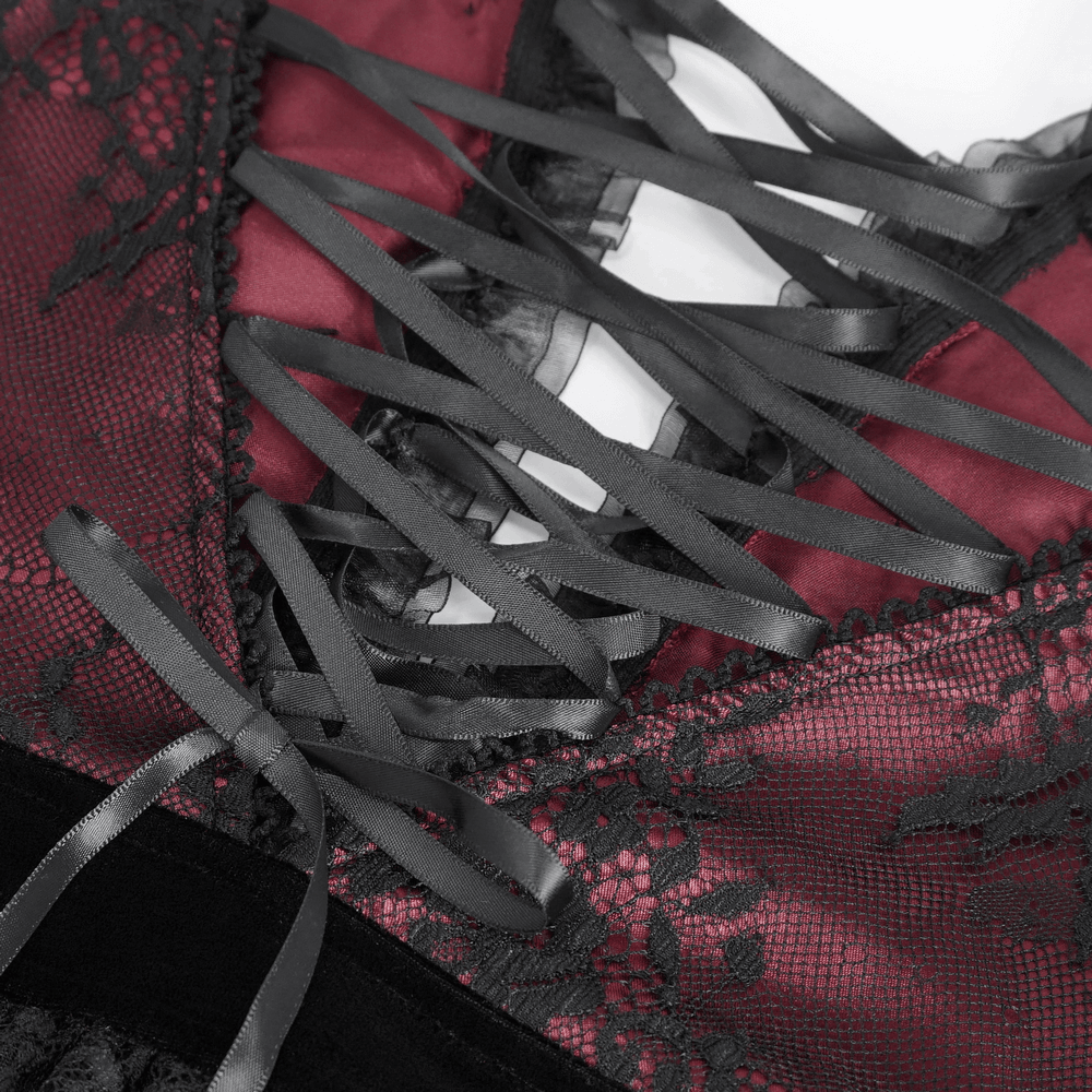 Close-up of intricate black lace detailing and dramatic ribbon lacing on a gothic Victorian style top.