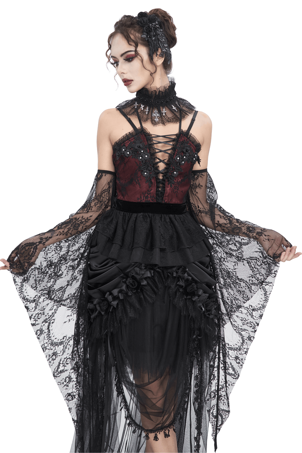 Gothic Victorian-style model in black lace top with dramatic bell sleeves and intricate lace details.