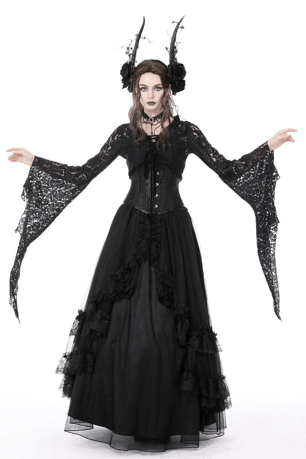 Gothic model wearing a black lace bolero shrug top with bell sleeves and a long black skirt, showcasing a dramatic dark style.