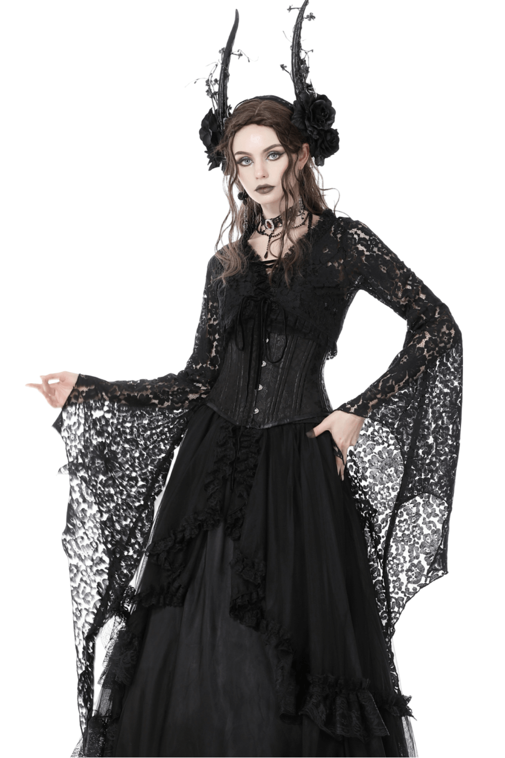 Gothic model in black lace bolero shrug with bell sleeves, styled with horns and flowers for a darkly elegant look.