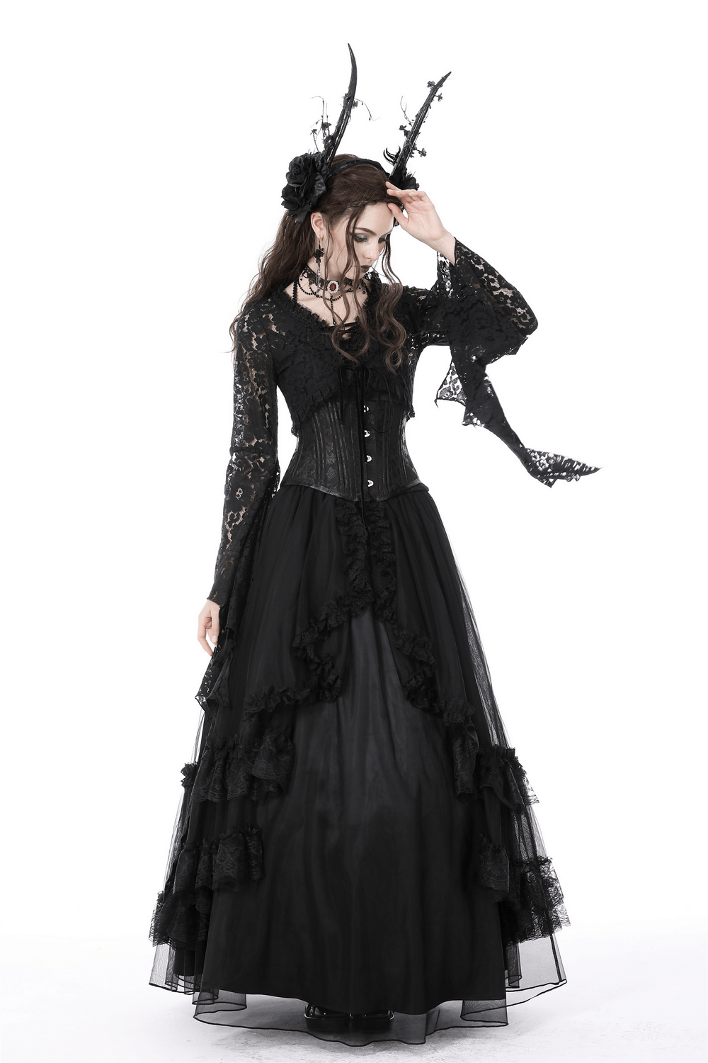 Ethereal gothic model in black lace bolero shrug top with dramatic bell sleeves, styled with flowing black skirt and dark accessories.
