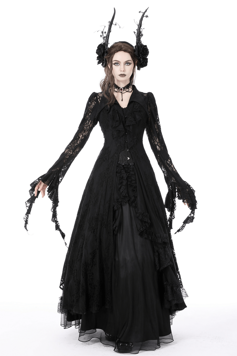 Gothic model in a dramatic black lace cape with intricate cutouts, embodying dark romance and elegant allure.