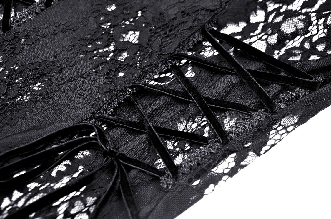 Close-up of black lace cape with intricate cutouts and velvet detailing, embodying gothic romance and allure.