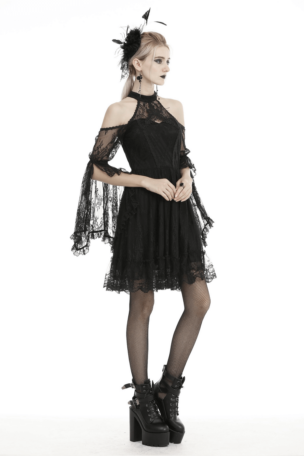Model wearing a black lace cold shoulder dress with sheer bell sleeves, choker neck, and edgy lace details.