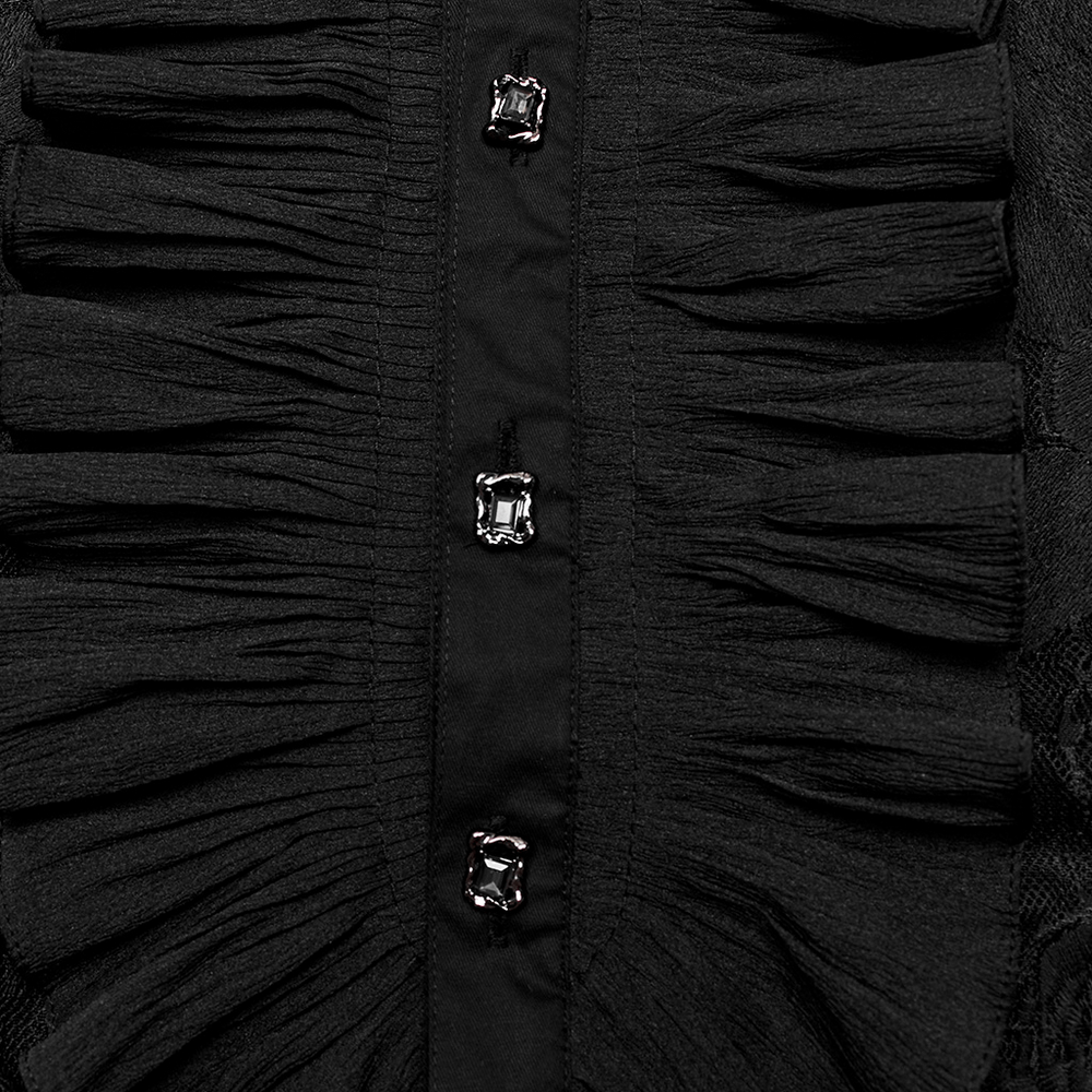 Close-up of black lace embroidered shirt detailing featuring ruffles and decorative buttons.