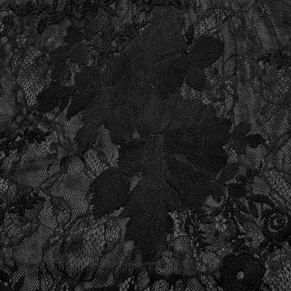 Close-up of intricate black lace floral embroidery, showcasing gothic elegance and detailed craftsmanship.