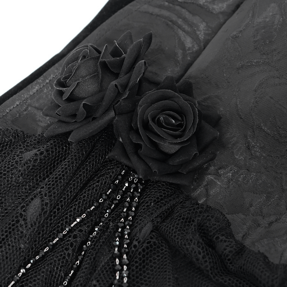 Close-up of black lace detailing featuring roses and chains, perfect for a gothic-inspired halterneck top.
