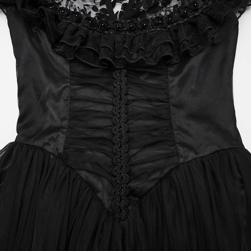 Close-up of black lace gothic dress showcasing ruffle detailing, corset waist, and elegant satin fabric.