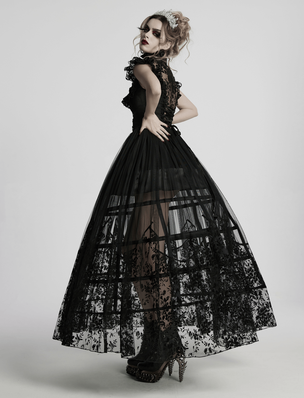 Black lace gothic dress with ruffle sleeves, sheer floral overlay, and flowing skirt, perfect for witchy soirées.