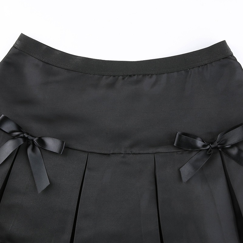 Black lace gothic mini skirt with pleats and decorative bows, perfect for stylish and edgy outfits.