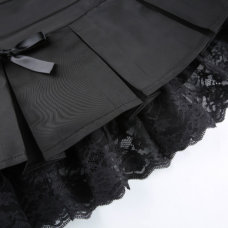 Detail of a black lace gothic mini skirt with pleats and bows, showcasing its elegant design and texture.