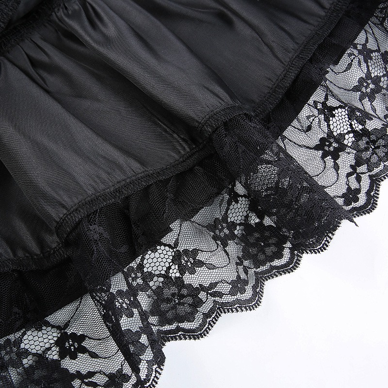 Close-up of black lace trim on gothic mini skirt, showcasing delicate patterns and pleated design.