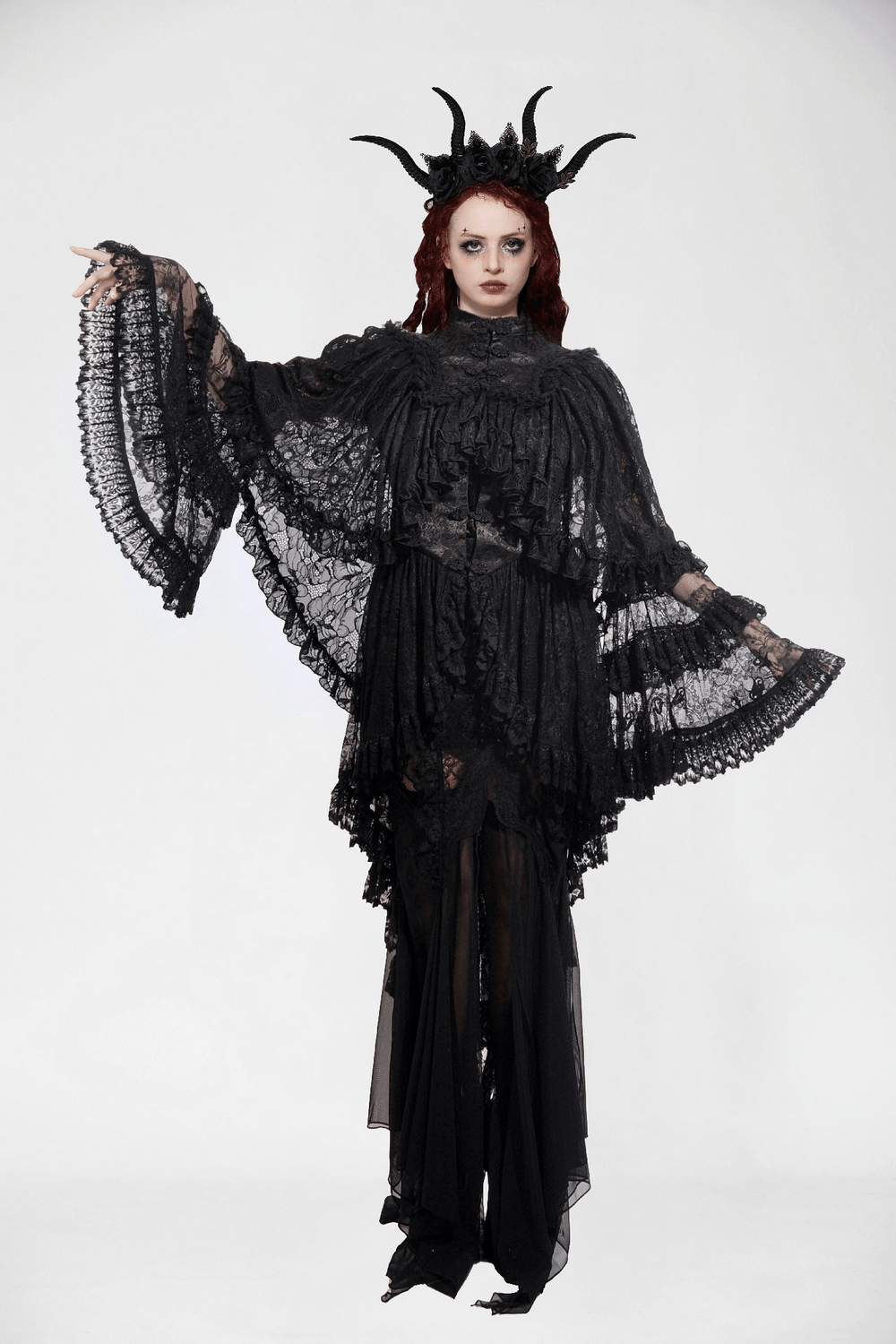 Elegant woman in black lace gothic ruffle cape with high collar and sleeves, exuding alternative fashion flair.