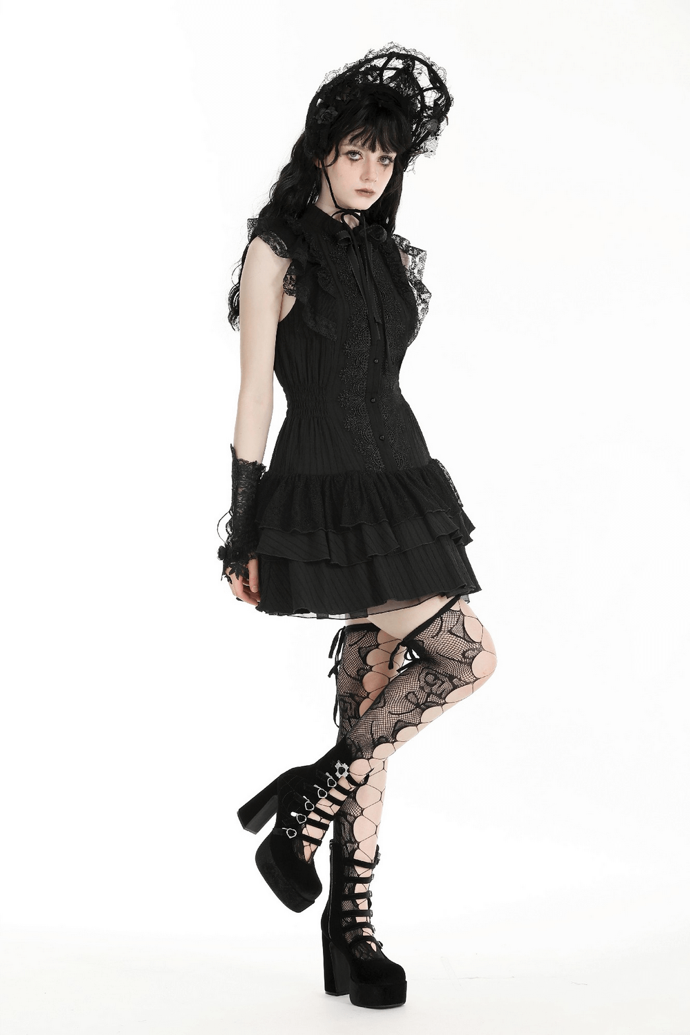 Gothic black lace ruffled dress with ribbon detail, paired with lace stockings and platform shoes, embodying elegance.