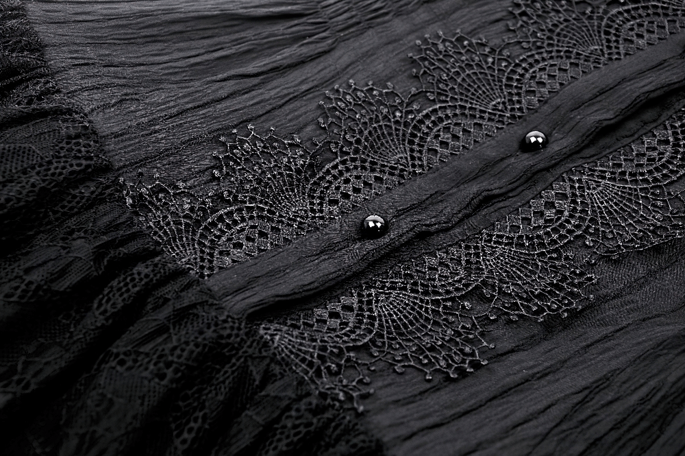 Elegant black lace detail and buttons on gothic ruffled dress showcasing intricate craftsmanship.