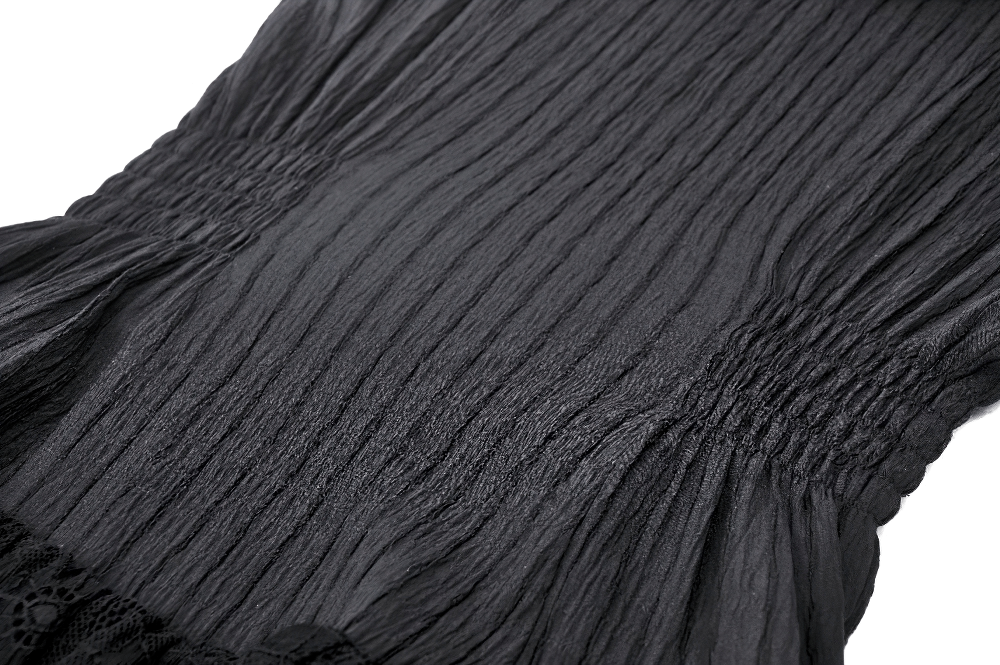 Close-up of black lace gothic dress featuring elegant smocking and ruffled details for a sophisticated gothic look.