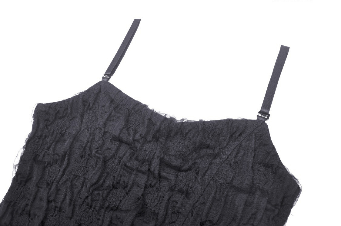 Close-up of black lace dress straps, showcasing delicate ruffles and gothic design details for a romantic look.