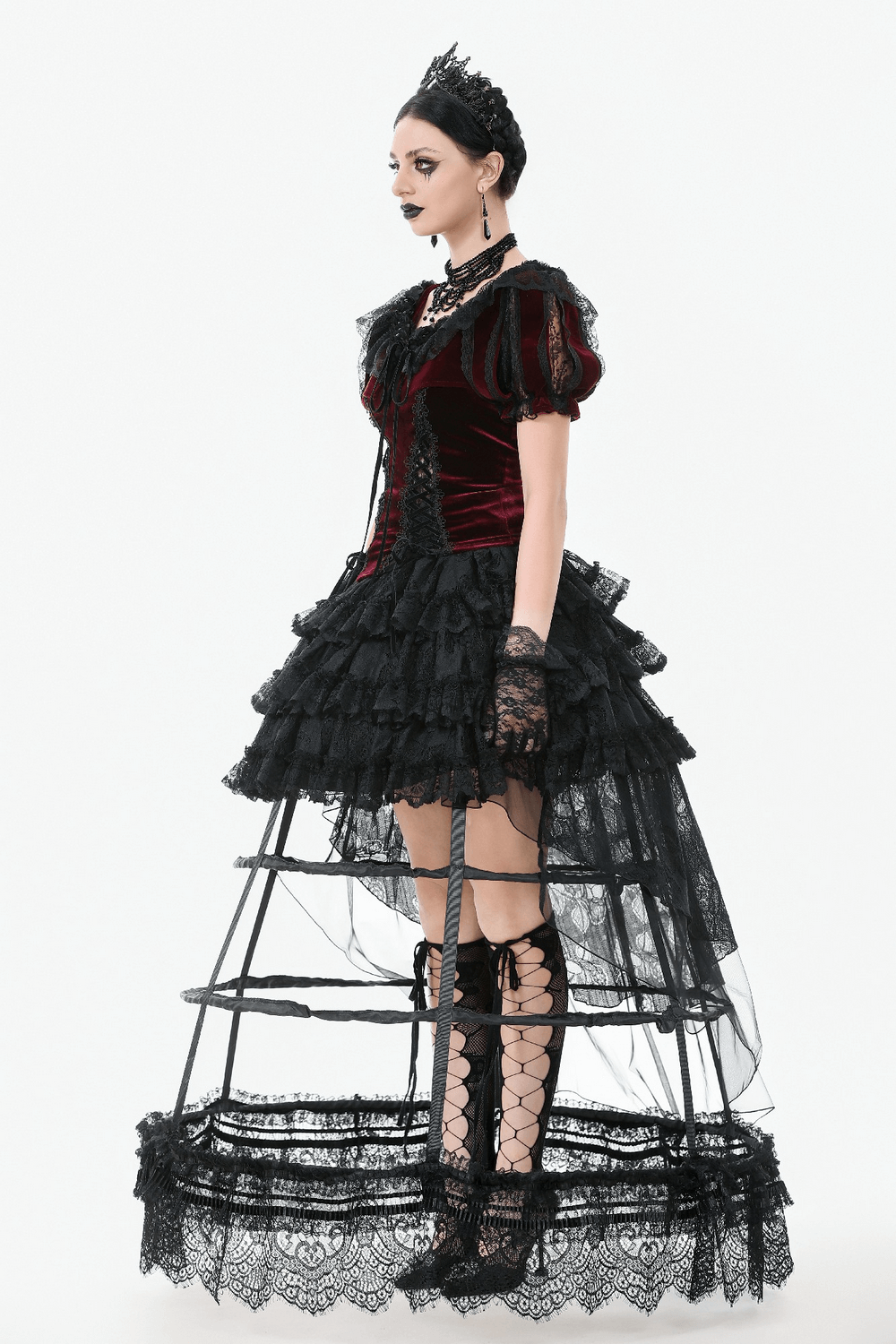 Model showcasing a black lace hoop petticoat with gothic details and layered ruffles, exuding vintage elegance.