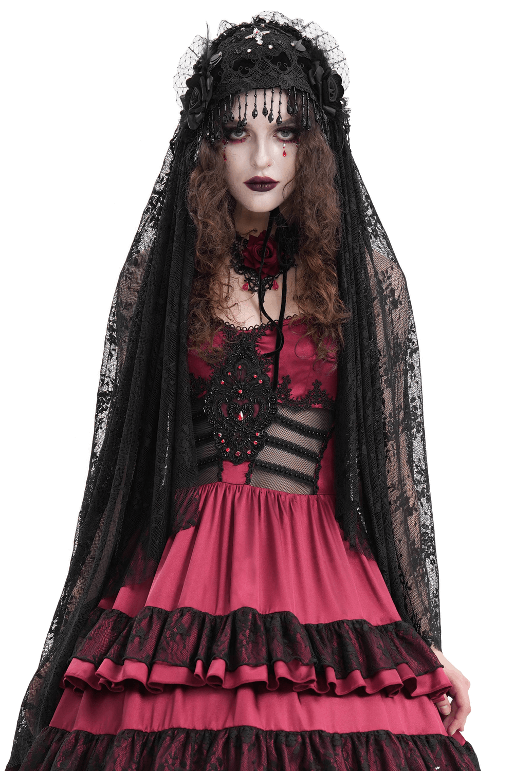 Gothic woman in black lace long veil and red dress, showcasing dark fashion and elegant style.