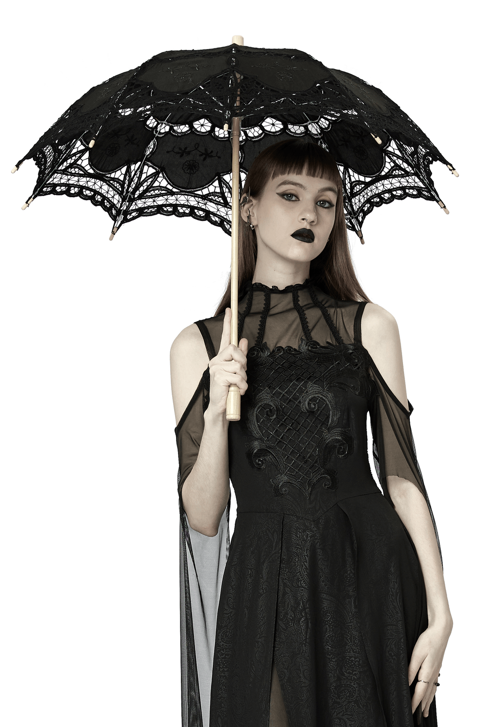 Elegant black lace parasol with embroidery held by a model in gothic attire, showcasing ethereal charm.