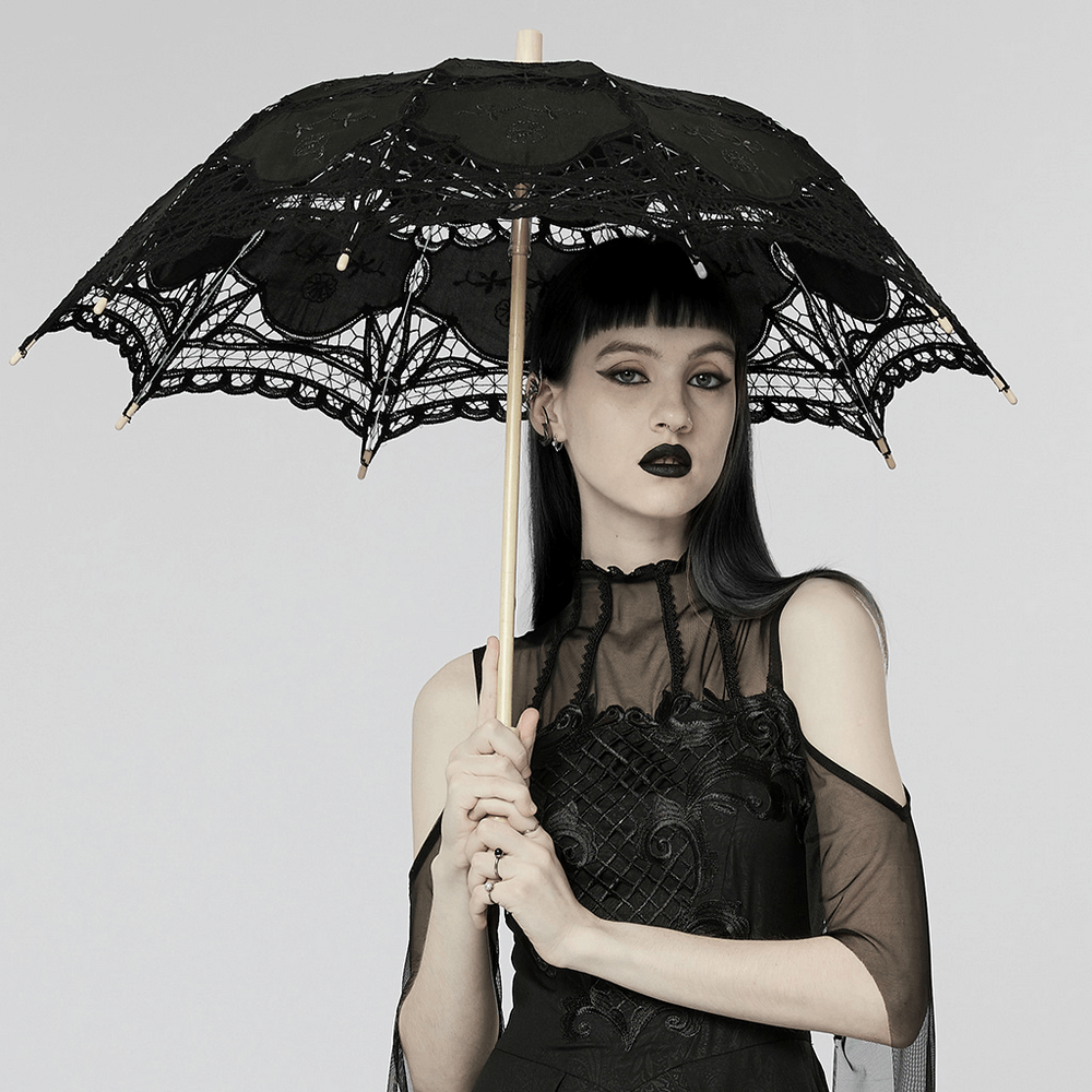 Elegant black lace parasol with embroidery, held by a model in gothic attire, perfect for Victorian or cosplay events.