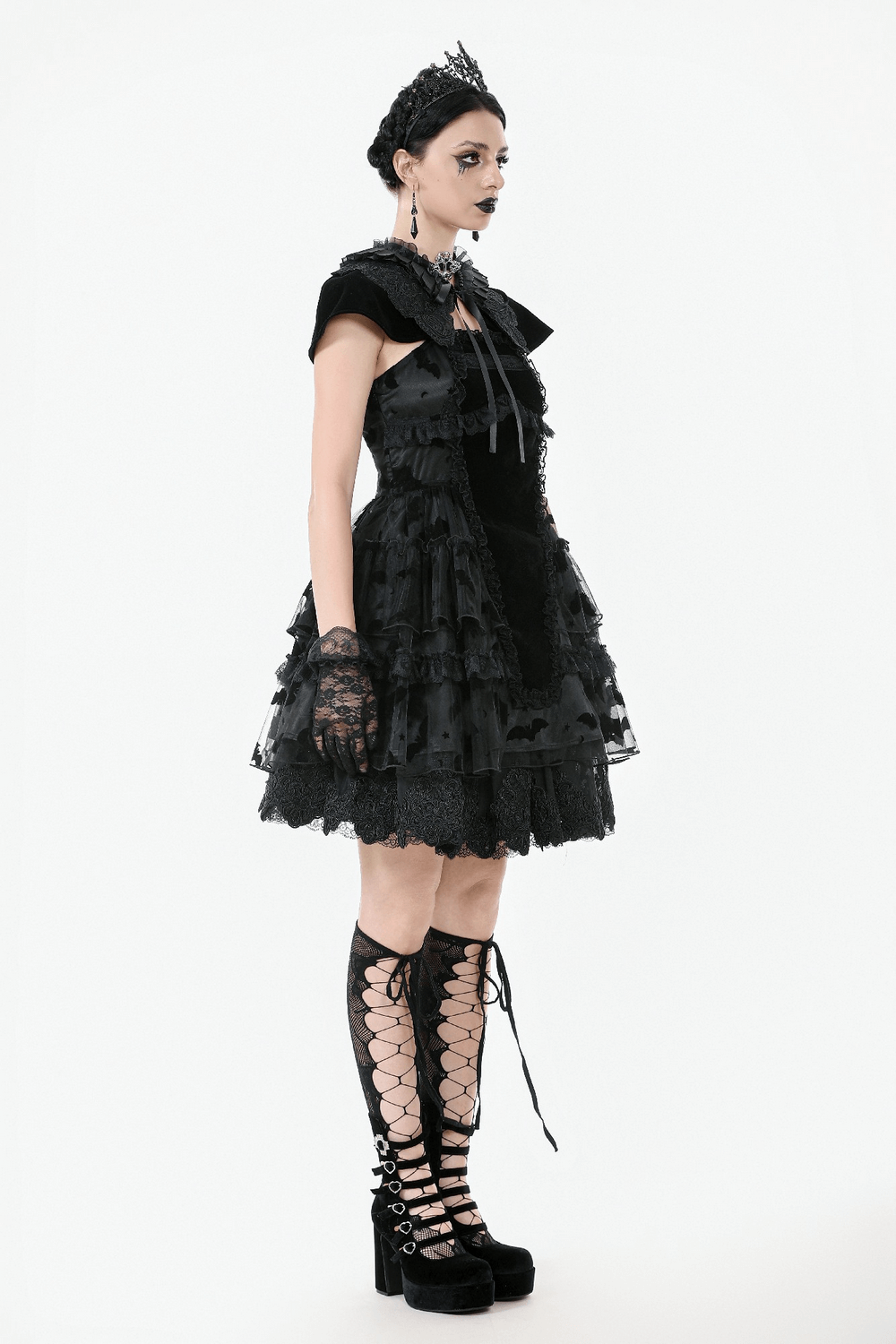 Stylish model in a black lace ruffled Gothic dress with bat print, lace-up details, and elegant accessories.