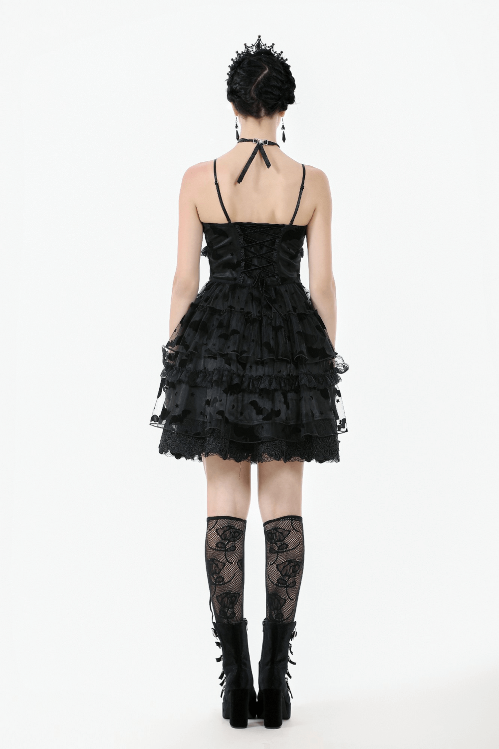 Back view of black lace ruffled gothic dress with bat print, adjustable straps, and lace-up detail.