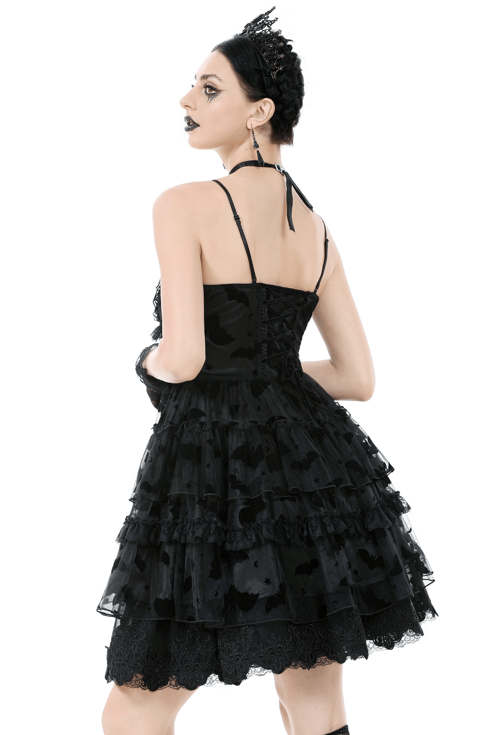Back view of a black lace ruffled Gothic dress with bat print and lace-up details, showcasing its elegant layers.