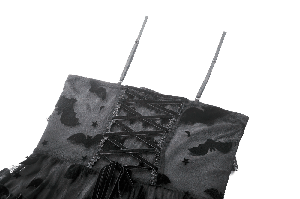 Close-up of a black gothic dress featuring bat print, lace-up front, and adjustable straps for a vintage touch.