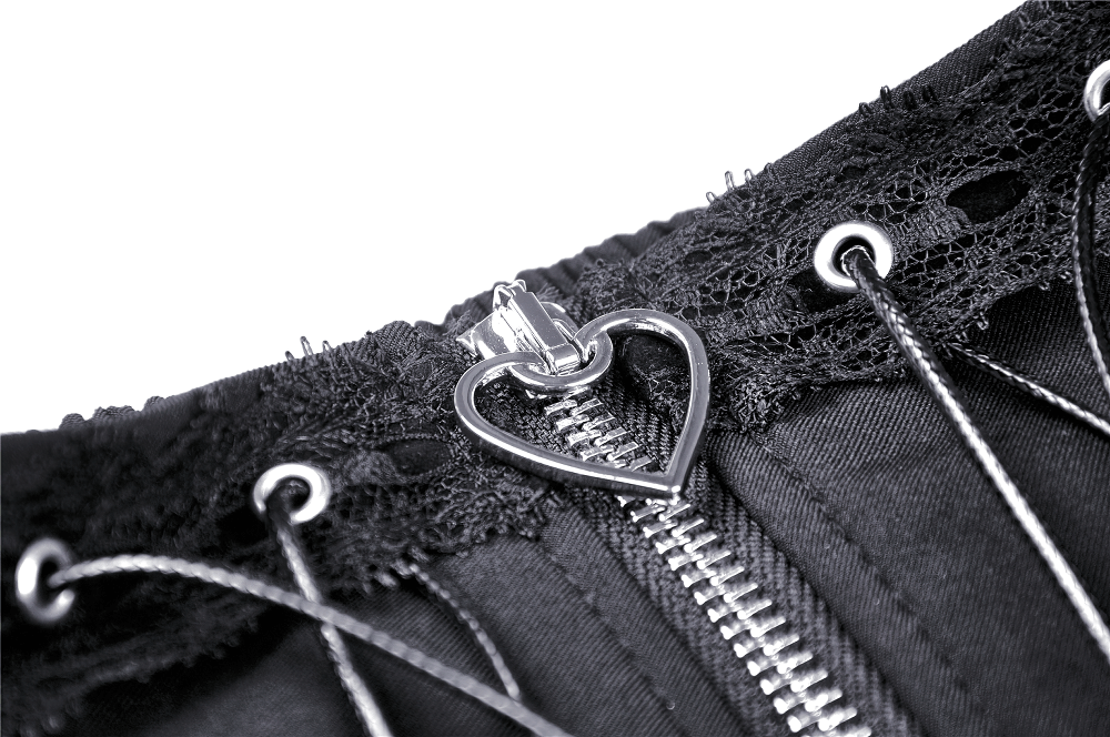 Close-up of black lace skirt detail featuring heart-shaped lacing and zip closure for gothic elegance.