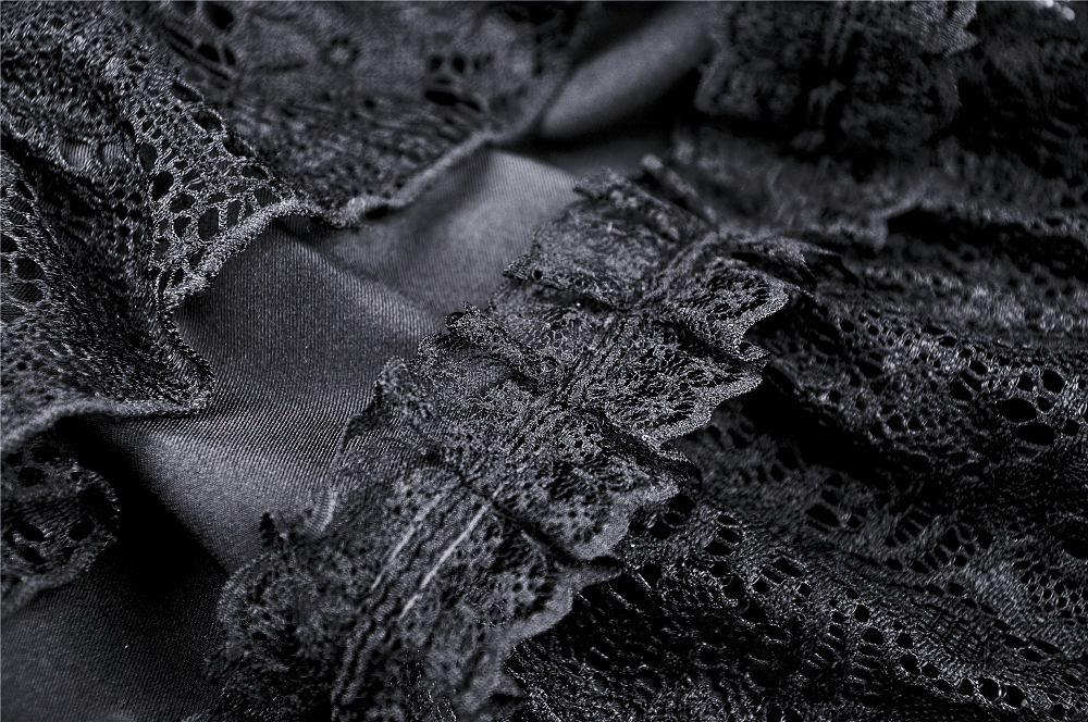 Close-up of black lace ruffles on a gothic skirt, showcasing intricate detailing and elegant texture.
