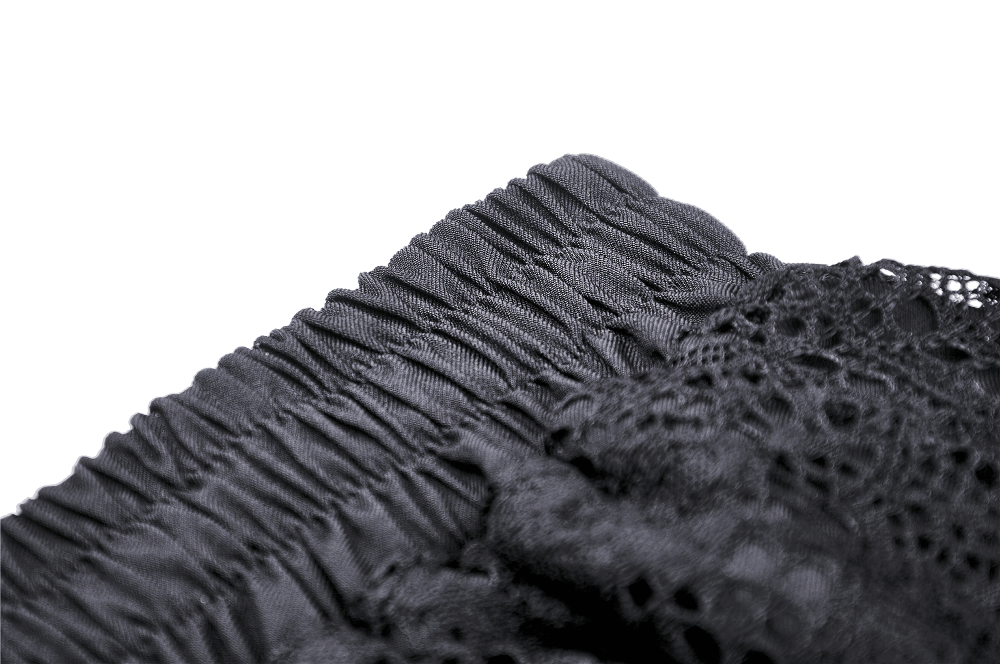 Close-up of black lace ruffled skirt showing delicate ruffles and intricate lace details.