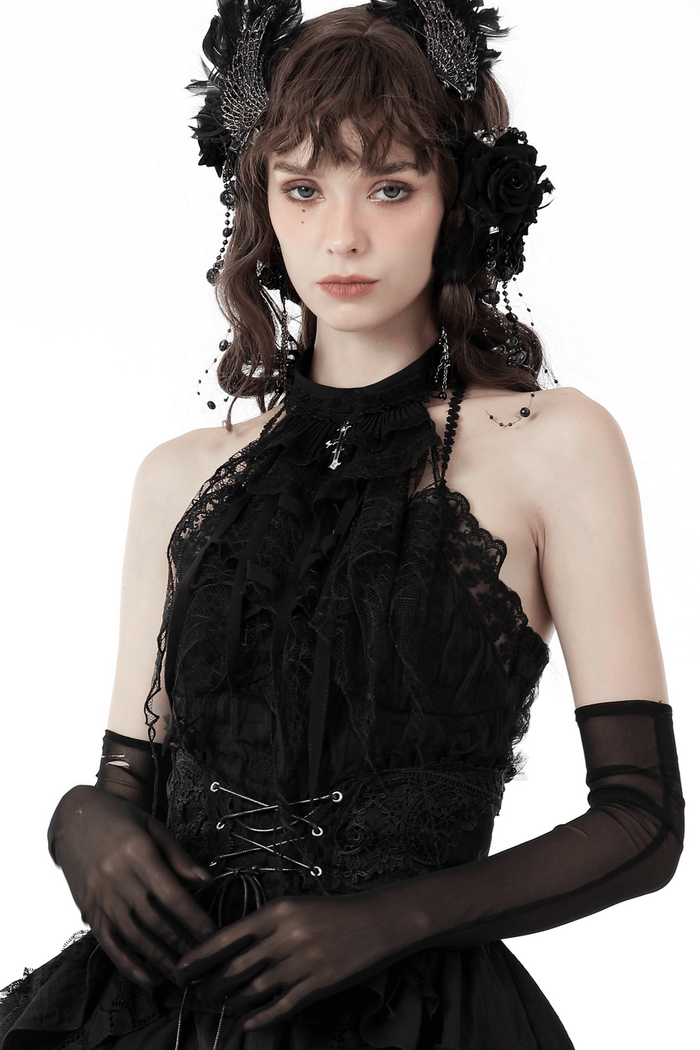 Gothic model in black lace neck tie, adorned with silver cross pendant, perfect for Halloween attire.