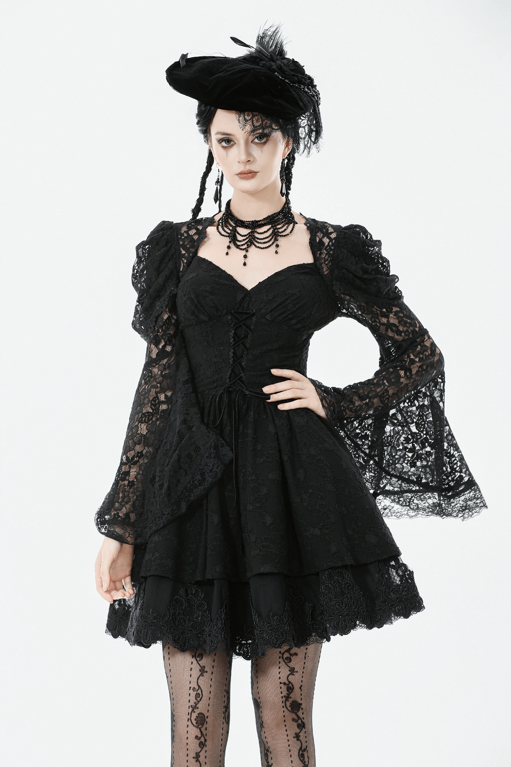 Black Lace-Up Gothic Mini Dress with Bell Sleeves showcased on a model, featuring bell sleeves and intricate lace detailing.