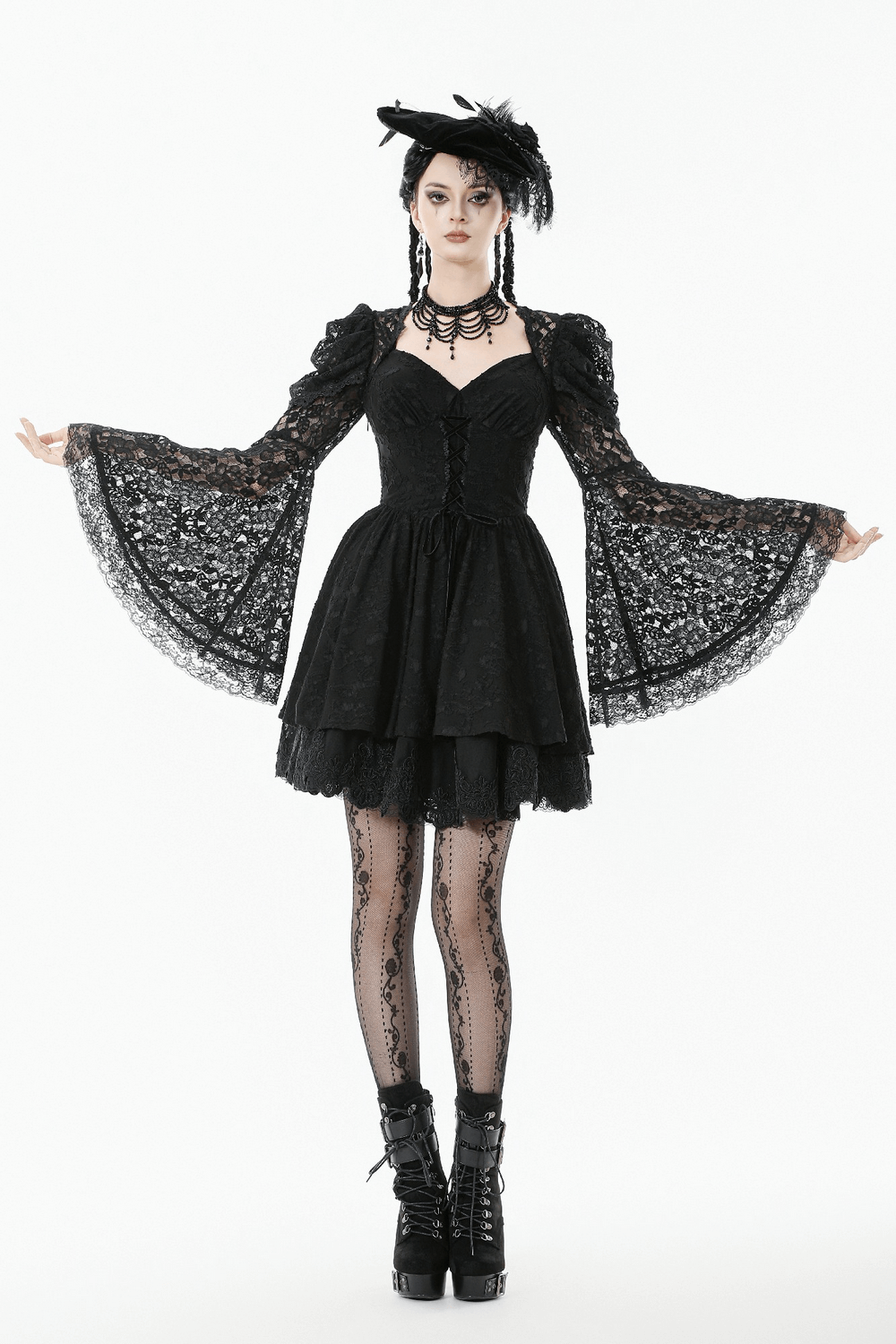 Black Lace-Up Gothic Mini Dress with Bell Sleeves worn by model, featuring intricate lace and flared sleeves.